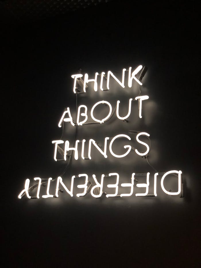 neon-signage-2681319 A glowing neon sign displaying an upside-down motivational quote against a dark background.